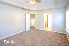 Summerville house for rent - A spacious room with a carpeted floor and a ceiling fan.