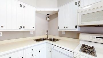 Crown Point apartment for rent - a white kitchen with white cabinets and a sink