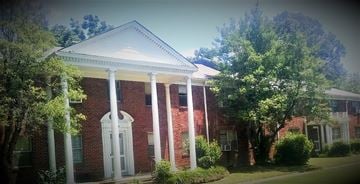 Memphis apartment for rent - a red brick house with white columns    and trees