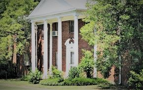 Memphis apartment for rent - the front of a brick house with columns and a white porch