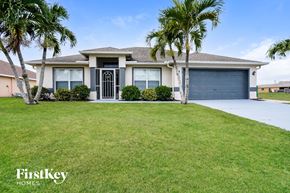 Cape Coral house for rent - A house with a palm tree in front of it.