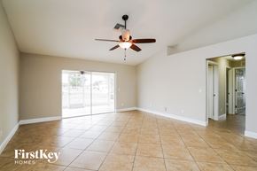 Cape Coral house for rent - A spacious room with a ceiling fan and tiled flooring.