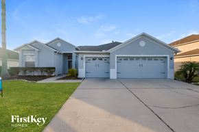 Land O Lakes house for rent - a blue house with a garage and a driveway