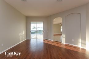 Land O Lakes house for rent - a living room with a hardwood floor and a door to a swimming pool