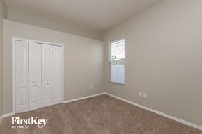 Land O Lakes house for rent - a bedroom with carpet and a window and two closets