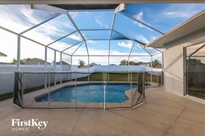 Land O Lakes house for rent - a small pool in a glass enclosure on a patio
