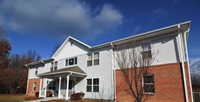 Frostburg apartment for rent - a white house with a blue sky in the background