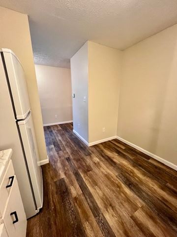 Columbus apartment for rent - A kitchen with a white refrigerator and wooden floors.