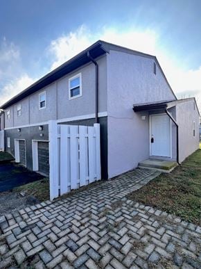 Columbus apartment for rent - A house with a grey and white exterior and a white door.
