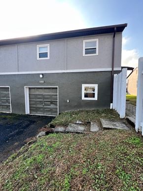 Columbus apartment for rent - A grey house with a white door and windows.