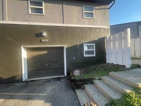 Columbus apartment for rent - a brown house with a brown garage door and stairs