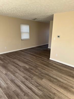 Columbus apartment for rent - an empty living room with wooden floors and a window