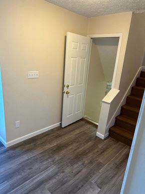 Columbus apartment for rent - a view of a hallway with stairs and a white door