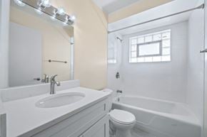 Oak Lawn apartment for rent - A white bathroom with a sink, toilet, and bathtub.