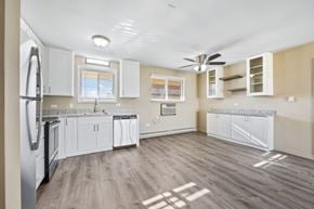 Oak Lawn apartment for rent - A kitchen with a refrigerator, cabinets, and a ceiling fan.