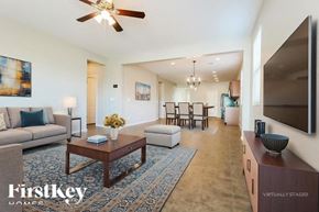 Buckeye house for rent - A living room with a couch, a coffee table, and a television.