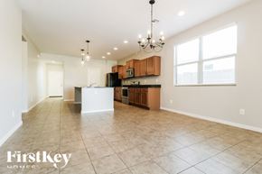 Buckeye house for rent - A spacious kitchen with a dining area and a chandelier.