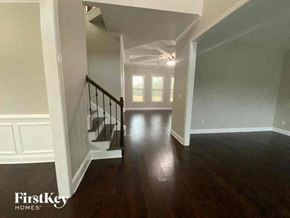Buford house for rent - a hallway with a staircase and a hard wood floor