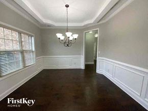Buford house for rent - a empty dining room with white walls and a large window