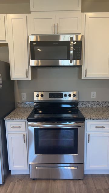 Washington apartment for rent - A modern kitchen with a stainless steel oven and microwave above it.