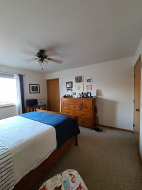 Eau Claire apartment for rent - a bedroom with a bed and a ceiling fan