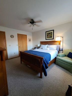 Eau Claire apartment for rent - a bedroom with a bed and a ceiling fan