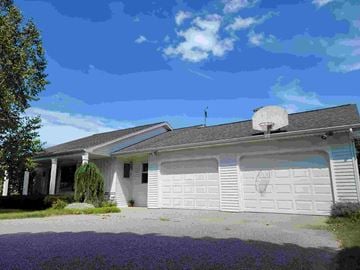 Petoskey house for rent - a white house with a satellite dish on the roof