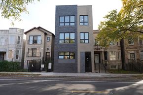 Chicago apartment for rent - the exterior of the building is black and gray and there are