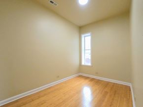 Chicago apartment for rent - an empty room with wooden floors and a window