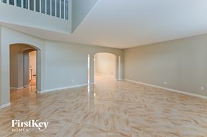 Richmond house for rent - A spacious room with wooden flooring and a FirstKey Homes logo.