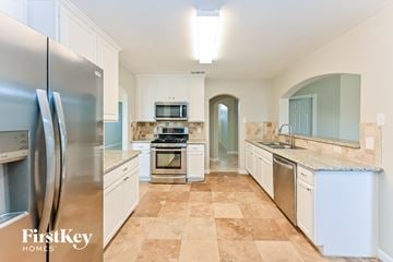 Richmond house for rent - A kitchen with a tile floor and a refrigerator.