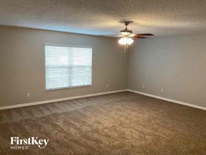 Sanford house for rent - an empty room with a ceiling fan and a window