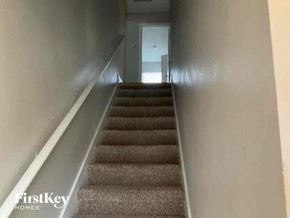Sanford house for rent - a set of stairs with carpet and a door