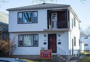 Milwaukee apartment for rent - a white house with a red sign in front of it