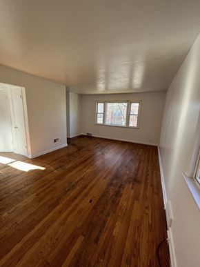 Milwaukee apartment for rent - an empty living room with wooden floors and a window
