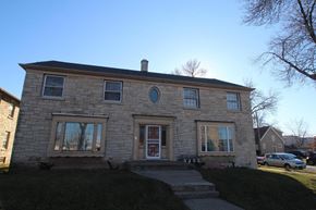 Milwaukee apartment for rent - the front of a brick house with a clear blue sky