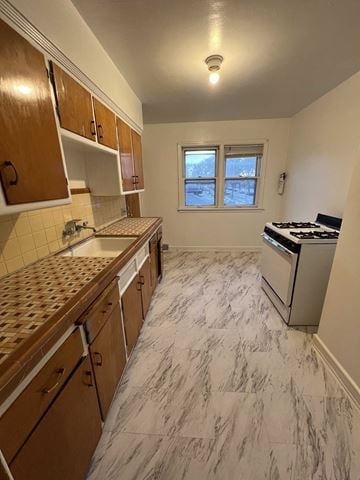 Milwaukee apartment for rent - an empty kitchen with a stove and a sink