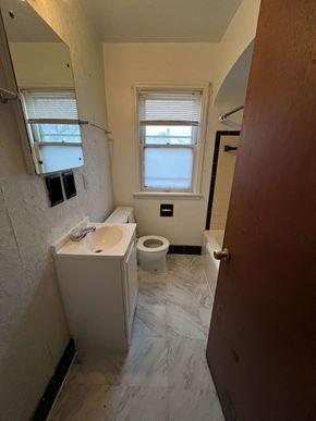 Milwaukee apartment for rent - a bathroom with a toilet and a sink and a window