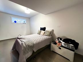Regina apartment for rent - a small bedroom with a bed and a dresser