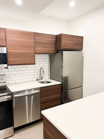 Regina apartment for rent - a kitchen with stainless steel appliances and wooden cabinets