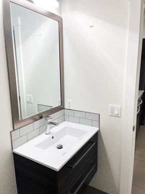 Regina apartment for rent - a small bathroom with a sink and a mirror