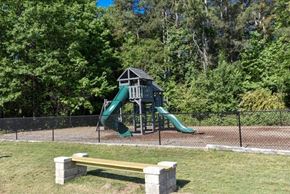 Ellenwood apartment for rent - A playground with a green slide and a yellow bench.