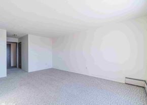 Wainwright apartment for rent - an empty living room with white walls and carpet