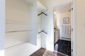 Calgary apartment for rent - A white hallway with a black and white tiled floor.