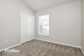 Orlando house for rent - a bedroom with carpet and a door and a window