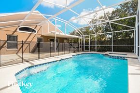 Orlando house for rent - a large swimming pool in front of a house