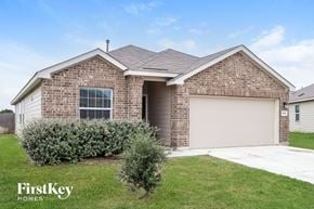 San Antonio house for rent - A brick house with a garage door is for sale by FirstKey Homes.