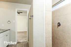 San Antonio house for rent - A bathroom with a shower and a doorway leading to a bedroom.