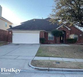 Mansfield house for rent - A brick house with a white garage door is for sale.