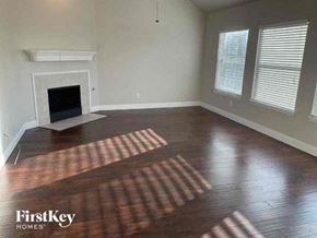 Mansfield house for rent - A room with a fireplace and wooden floors.